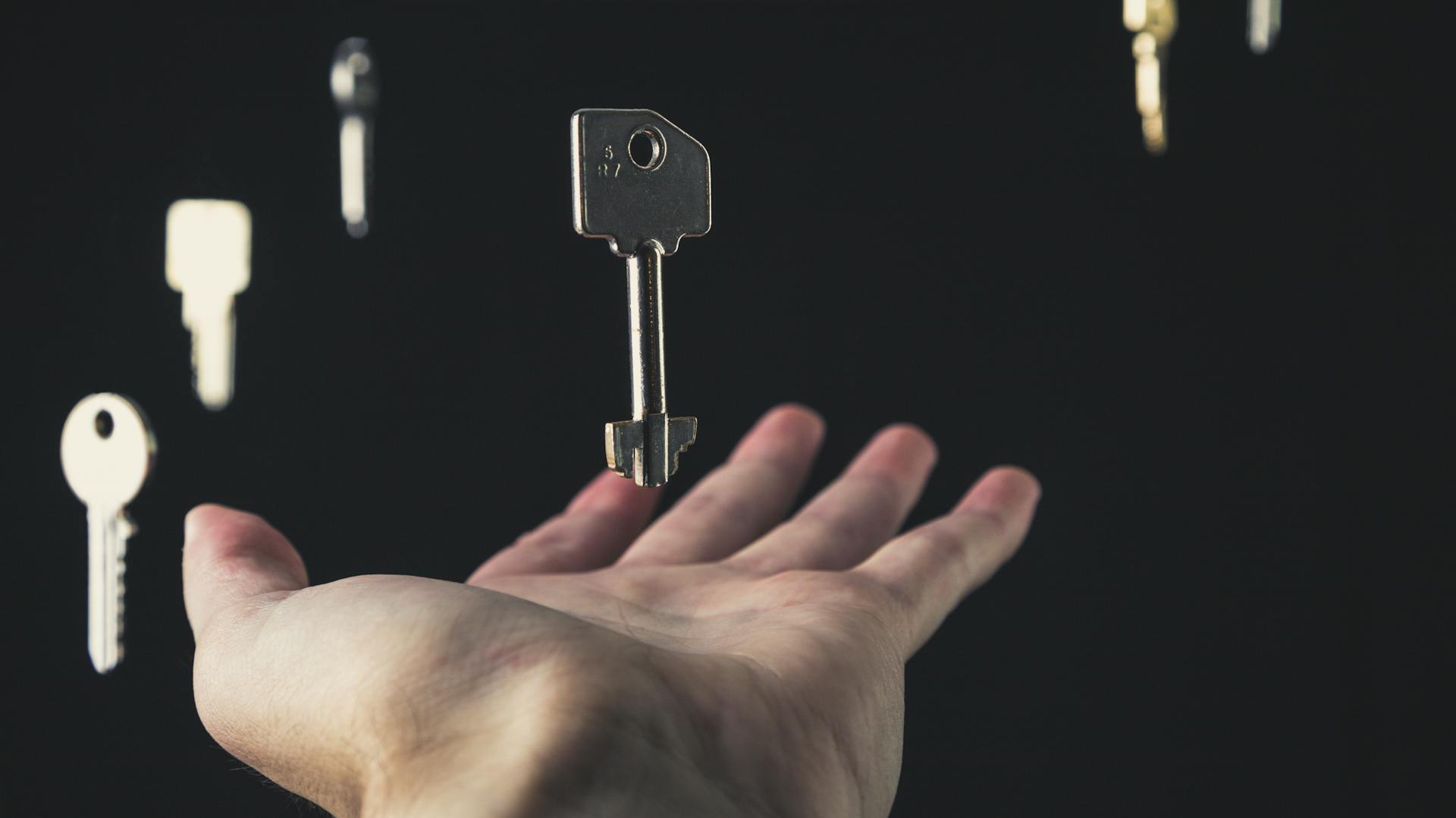 Keys floating with a hand reaching out